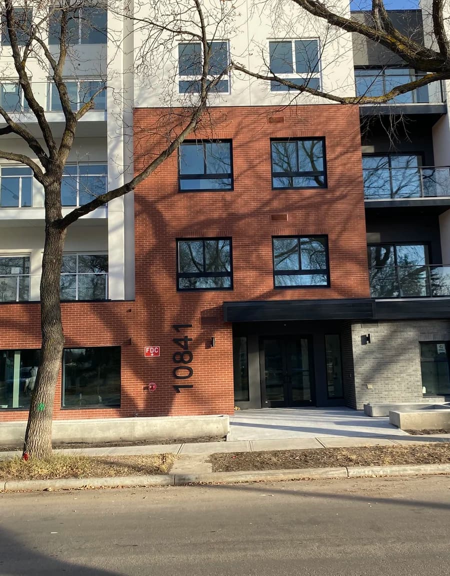 Red brick condo street view with trees